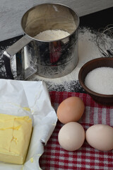 sifted flour, eggs and butter on the table