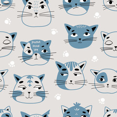 Vector seamless children's pattern with cat faces on a blue background. Suitable for baby prints, baby room decor, wallpapers, wrapping paper, stationery, scrapbooking, etc.