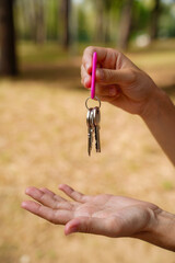 Woman with house keys outdoors beginning a new life