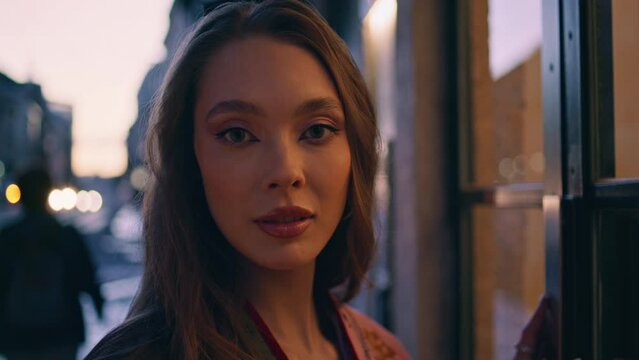 Portrait luxury woman dusk street looking camera. Model posing urban avenue