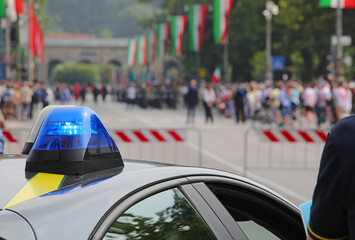 flashing police car and white red green flags during the ceremony