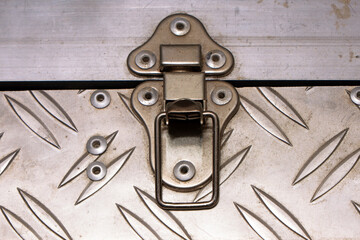 Open iron lock of an iron suitcase.
