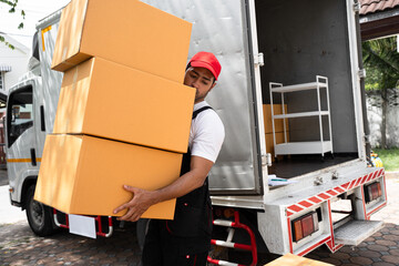 Delivery men carrying or holding cardboard box with shipping truck background