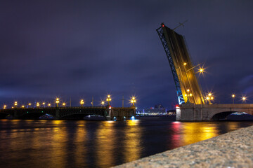 Fototapeta na wymiar Picturesque night view of the raised bridge across the Neva River in St. Petersburg