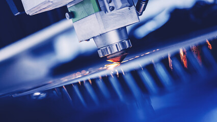 Blue color Laser CNC cut of metal with light spark, technology modern industrial banner