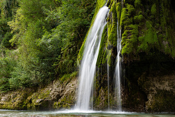 Fototapeta na wymiar Georgia waterfall through rocks and moss