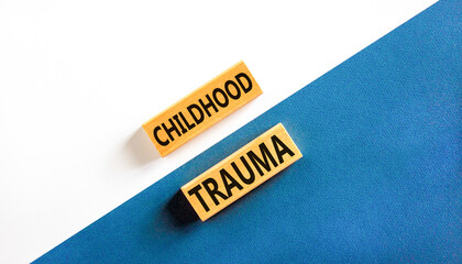 Childhood trauma symbol. Concept words Childhood trauma on beautiful wooden blocks. Beautiful white...