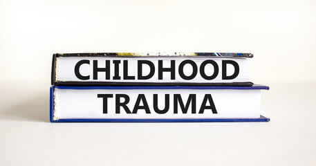 Childhood trauma symbol. Concept words Childhood trauma on beautiful books. Beautiful white table...