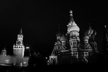 The black and white photo of the Spasskaya Tower of Moscow Kremlin and Saint Basil's Cathedral on...