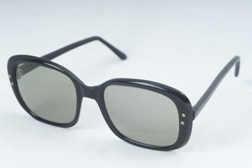 Angled View Retro Designer Fashion Sunglasses Black Frames On Natural Background