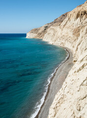 Rocky coastline ocean water. White cliffs and pebble beach.