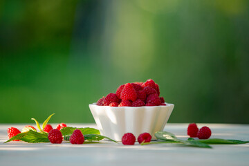 Fresh raspberries on a table in the garden