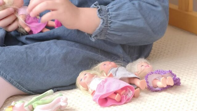 mother-daughter doll play can reflect cultural norms and traditions, offering insights into societal values, close-up of children's hands with toys, therapeutic activities