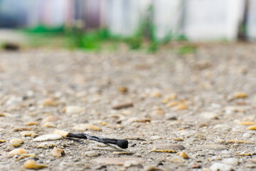 A match, a hand with a matches against the background of old garages in city.