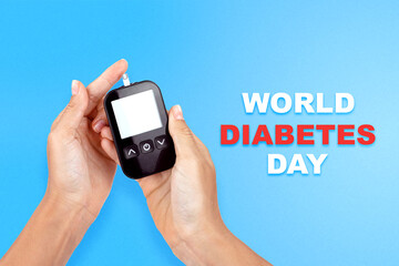 World Diabetes Day November 14, there is an electronic test strip for measuring glucose levels in the blood and body in young woman hands, the isolation on a blue background with world map, top view
