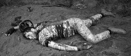 A wounded soldier lies on the ground