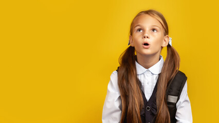 Wow. Shocked Schoolgirl On Yellow Background In Studio. Free Space For Text