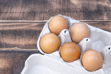 Chicken eggs in a paper tray. Brown chicken eggs. Chicken eggs close up. Domestic eggs.