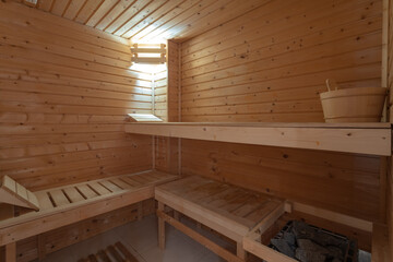 Sauna bath warm interior inside a barrel water bucket in a hotel for spa treatments.
