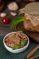 Turkey stew, meat preparations in a glass jar, cooked meat in a bowl