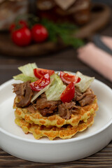 Fototapeta premium Turkey stew in glass jars, a portion of potato waffles with meat and vegetable salad