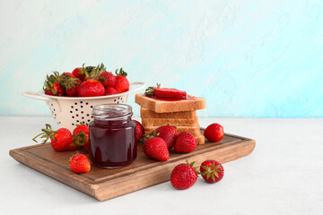 Wooden board of tasty toasts with sweet strawberry jam and fresh berries on table