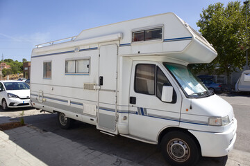 A motorhome parked on a street during a break from the trip to summer vacation
