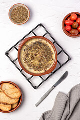 Food photography of provolone cheese, baked, melted, starter, italian, oregano, seasoning, toast, tomatoes, pottery