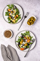 Food photography of salad; cheese manouri, feta; vegetable; tomato; cucumber; onion; lettuce; sauce; pepper; olive; seasoning