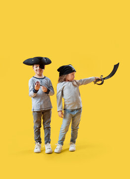 Cute little pirates with smoking pipe and sword on yellow background