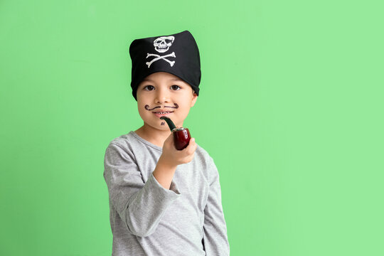 Cute little pirate with smoking pipe on green background