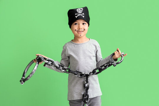 Cute little pirate with chain on green background