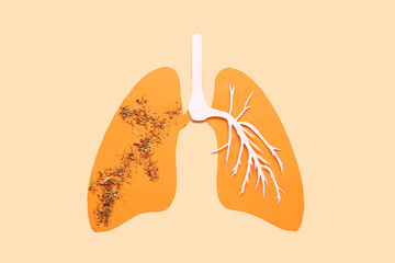 Paper lungs with tobacco on beige background. Lung cancer concept