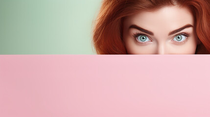 text space for advertising with funny part as portrait of irish female model with ginger hairs peeking over a colored panal