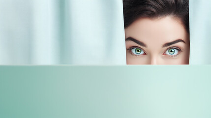text space for advertising for skin care or cosmetic as sample with part as portrait of a black haired female model peeking over a colored panal