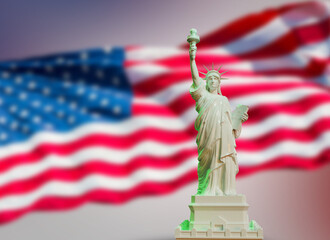 white statue of liberty on USA flag