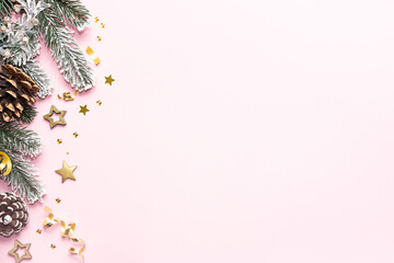 Beautiful Christmas border on light pink background with copy space for your design.