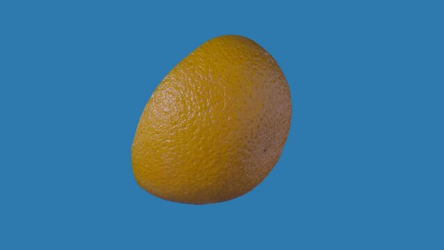 Healthy food advertisement creative concept. Closeup shot of tilted half of orange rotating suspended with all angles visible. Chroma key.