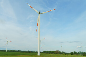 Landscape from renewable energy wind turbine with field, forest and sky