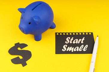 On a yellow background there is a piggy bank, a dollar symbol and paper with the inscription - Start Small - Powered by Adobe