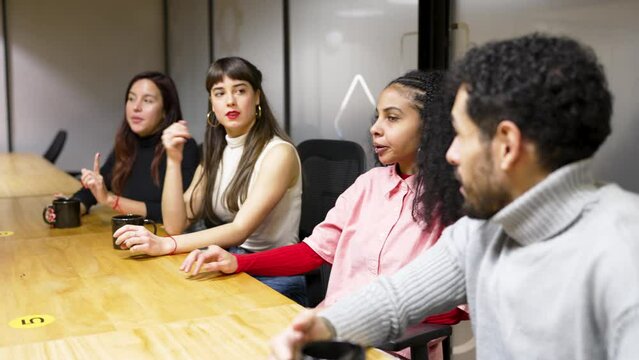 multiracial young group of employees or students in meeting room chatting planning