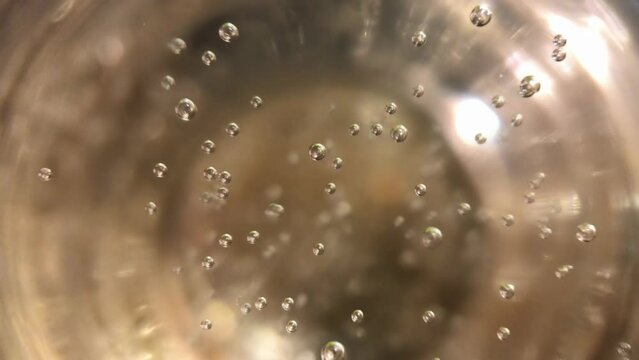 Top view close-up of effervescent bubbles in a champagne glass, a festive concept