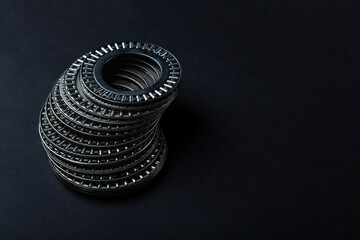 Lot of metal bearings on a dark background. Machinery concept, spare part of oil production...