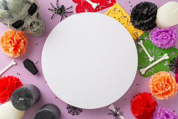 Mexican Day of the Dead comes alive! Top view of floral-adorned carnival decor. Confetti, garland, spooky accents, and pastel purple backdrop make a captivating composition with empty circle for text