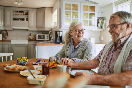 Senior Caucasian couple having breakfast together in the kitchen in the morning - Powered by Adobe