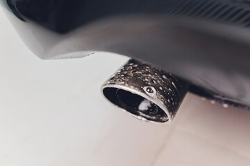 Car exhaust pipe with soap. Car wash background.