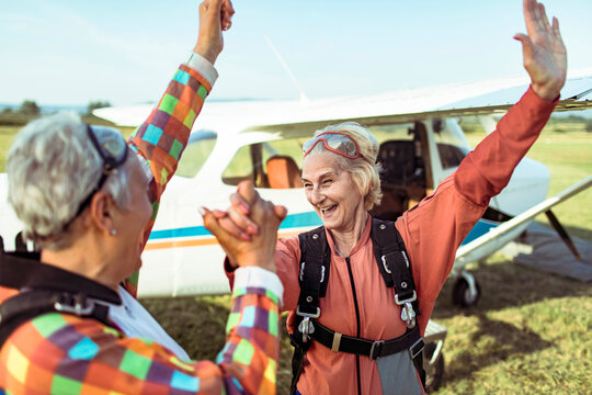 Senior lesbian couple getting ready to go skydiving together for their bucket list