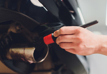 Car exhaust pipe with soap. Car wash background. brushing