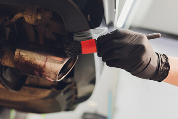 Car exhaust pipe with soap. Car wash background. brushing