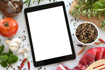 Tablet computer with mock up white screen in kitchen with food flat lay background. Online grocery shopping, takeout, food delivery app ads or recipe concept. - obrazy, fototapety, plakaty